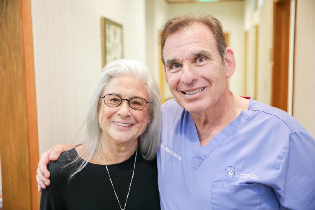 our dental implant specialist in Voorhees, NJ, smiling with his happy patient.
