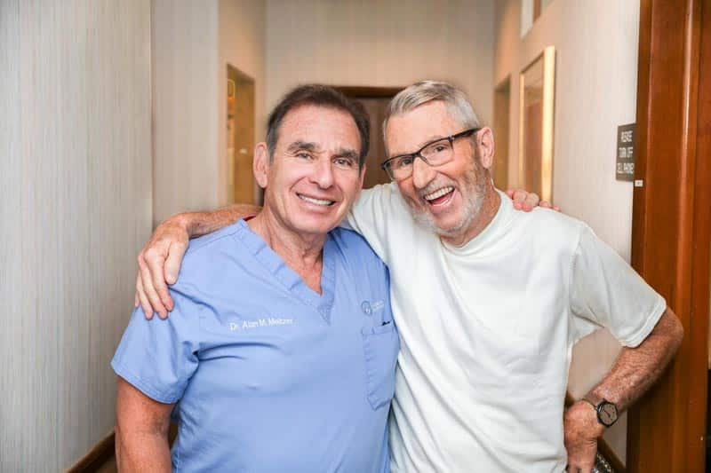 Dr. Meltzer, periodontist in Voorhees, with a happy patient.