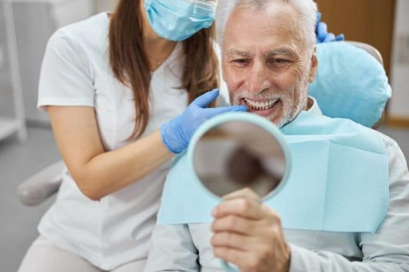 Untitled (800 × 600 px)-42 A patient admiring their new smile after getting dental implants in Cherry Hill, NJ.
